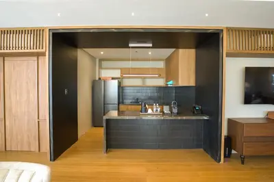 an open kitchen with a sink and a refrigerator at Brittany Hotel Villar City in Cavite