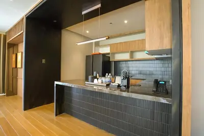 a kitchen with a black counter top in a room at Brittany Hotel Villar City in Cavite
