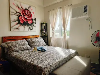 a bedroom with a bed with a stuffed animal on it at Happy Stays B - 300mbps - 65