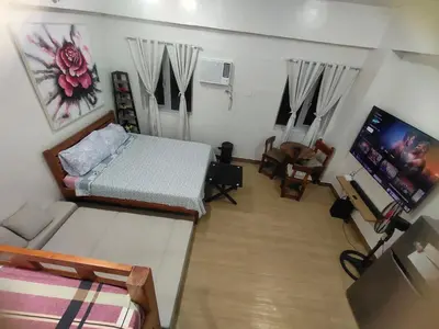 a living room with a bed and a couch at Happy Stays B - 300mbps - 65
