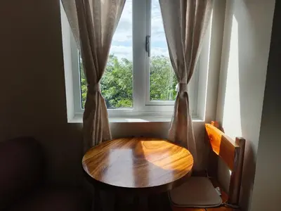a wooden table sitting in front of a window at Happy Stays B - 300mbps - 65
