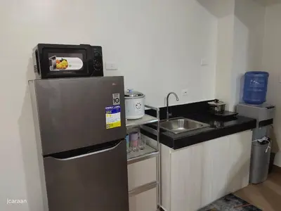 a small kitchen with a refrigerator and a sink at Happy Stays B - 300mbps - 65