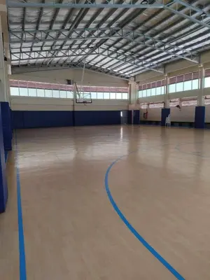 an empty gymnasium with a basketball hoop in the middle of a basketball court at 2-Bed Apartment in Near Airport Paranaque in Manila