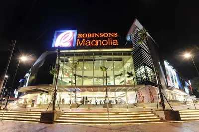 a building with a sign on it at night at Renovated 2br 2tb Wifi/Netflix very near Mall QC in Manila