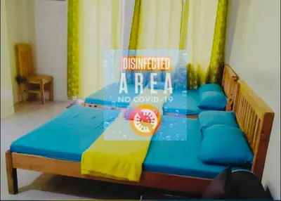 a bed in a room with a sign on it at Condo Premium Near NAIA T123 in Manila