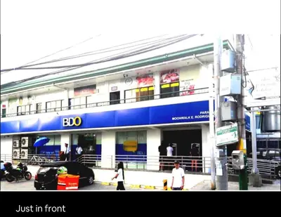a blue and white building with people walking in front of it at Condo Premium Near NAIA T123 in Manila