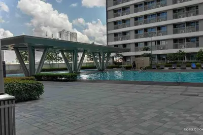 a swimming pool in front of a building at Minju Staycation at Fame Residences Free Netflix & Wifi in Manila