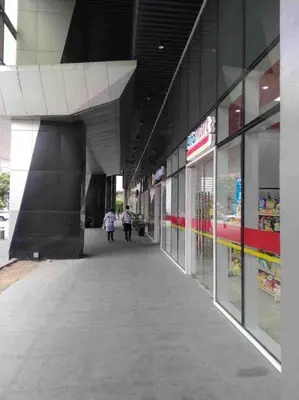 a hallway of a building with people walking in it at Minju Staycation at Fame Residences Free Netflix & Wifi in Manila