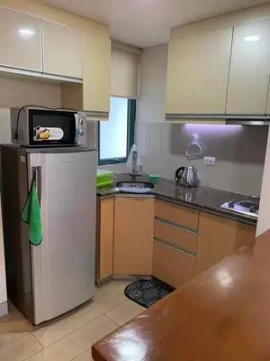 a kitchen with a refrigerator and a microwave at Airport staycation @MRMCONDOTEL in Manila