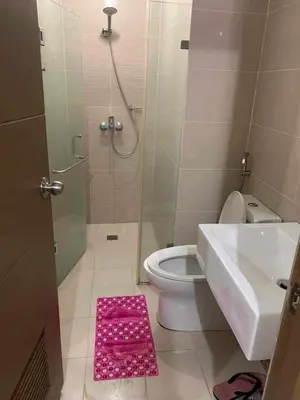 a bathroom with a shower and a toilet and a sink at Airport staycation @MRMCONDOTEL in Manila