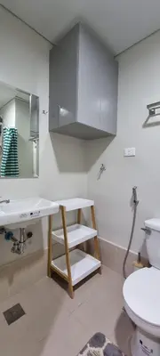a bathroom with a sink and a toilet at 2BR Irish Luck Holiday Apartment in Manila