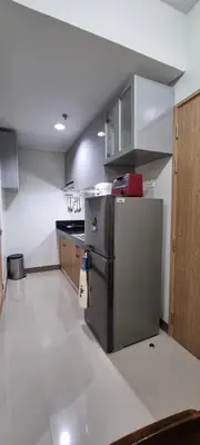 an empty kitchen with a stainless steel refrigerator at 2BR Irish Luck Holiday Apartment in Manila