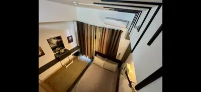 a small room with a couch and a window at H&H at Grace Residences in Manila