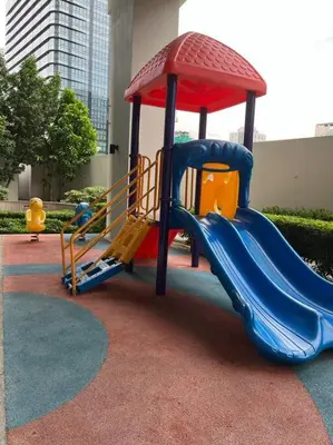 a playground with a slide in a park at BGC Uptown Mall Suite in Manila