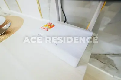 a box on a table with a ace registration sign on it at Air Residences Makati with Sunset View in Manila