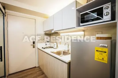 a small kitchen with a sink and a microwave at Air Residences Makati with Sunset View in Manila