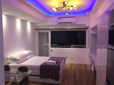 a bedroom with a bed with a purple ceiling at Cozy35sqm w parking balcony Wifi/Netflix near Mall in Manila