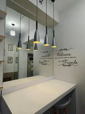 a kitchen with a counter with a mirror and some lights at Fresh Air in Heart of Makati in Manila