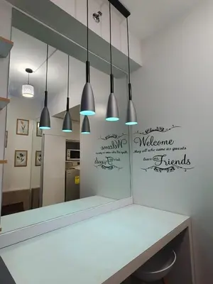 a mirror in a kitchen with a counter and lights at Fresh Air in Heart of Makati in Manila