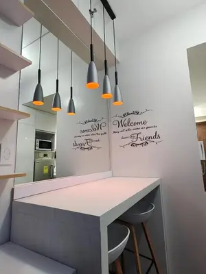 a kitchen with a counter and some pendant lights at Fresh Air in Heart of Makati in Manila