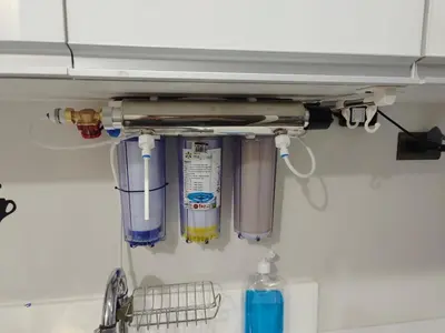 a shelf above a kitchen sink with some utensils at Fresh Air in Heart of Makati in Manila