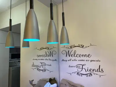 a kitchen with three lights hanging from a wall at Fresh Air in Heart of Makati in Manila
