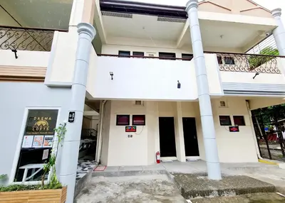a white building with white columns at Dasma Lofts Hotel near Dela Salle Dasma in Dasmariñas