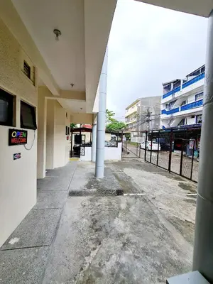 an empty hallway of a school building with columns at Dasma Lofts Hotel near Dela Salle Dasma in Dasmariñas