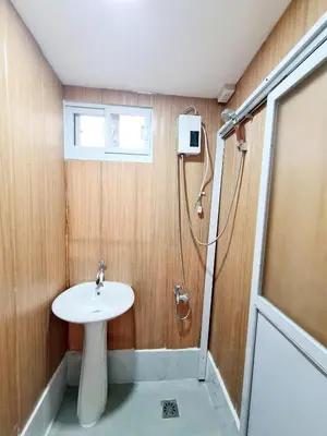 a bathroom with a sink and a shower at Dasma Lofts Hotel near Dela Salle Dasma in Dasmariñas