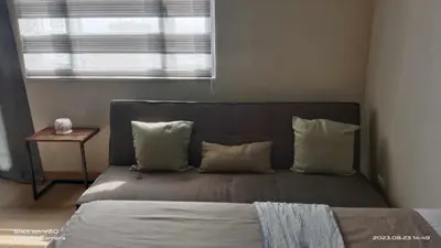 a bed with pillows and a window in a room at SonSon at Manhattan Plaza Tower 1, Araneta, Cubao, Quezon City in Manila