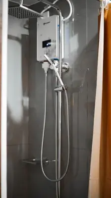 a shower in a bathroom with a shower at Smart Cozy Home Air Residences Makati in Manila