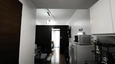 a kitchen with a refrigerator and a microwave at Smart Cozy Home Air Residences Makati in Manila