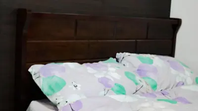 a bed with purple and green pillows on it at Smart Cozy Home Air Residences Makati in Manila