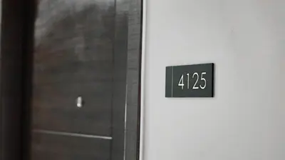 a clock on the side of a door at Smart Cozy Home Air Residences Makati in Manila