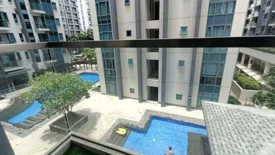 a view of the pool from the balcony of a building at Hilander's Condotel near Terminal 3 Airport in Manila