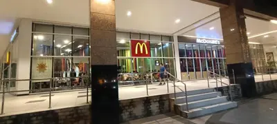 a mcdonalds store with a sign on the front of it at Hilander's Condotel near Terminal 3 Airport in Manila
