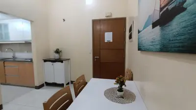 a kitchen and dining room with a table and chairs at Hilander's Condotel near Terminal 3 Airport in Manila