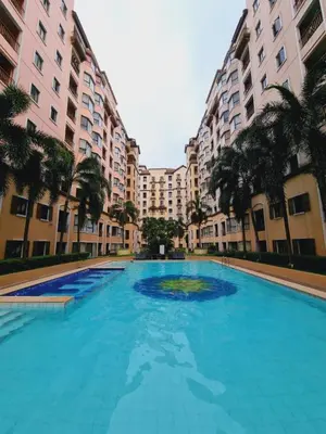 a large swimming pool in front of tall buildings at Modern Minimalist Condo near Airport in Manila