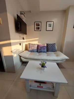 a living room with a couch and a table at 2BR Loft unit in Manila
