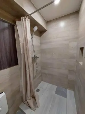 a bathroom with a shower with a shower curtain at 2BR Loft unit in Manila