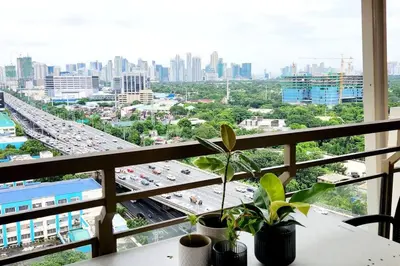 a balcony with a view of a city with traffic at Casa Antonio at Fairway Terraces Family Penthouse 2BR Wi-Fi Nr Golf, Airport, Fort BGC in Manila