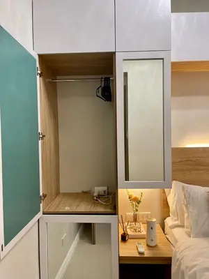 a small bedroom with a mirror and a bed at LuxeRN Suite at S Residences in Manila