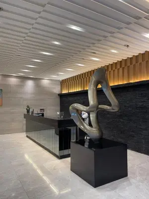 a metal sculpture sitting on a table in a lobby at LuxeRN Suite at S Residences in Manila