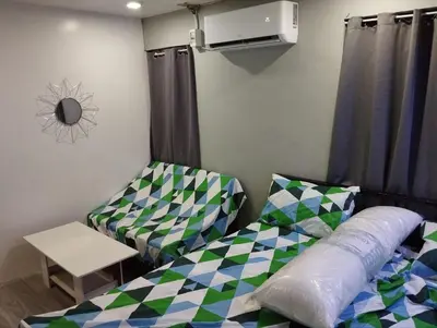 a room with a bed and a couch and a table at 9 Guest - Unit 1 House Type in Pasong Mannga