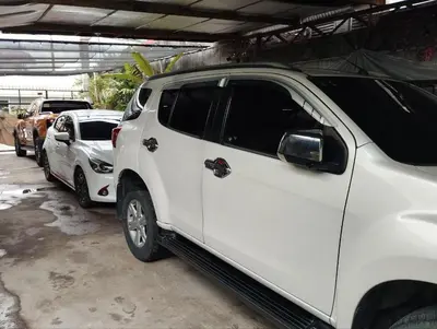 a white truck parked in a parking lot at 9 Guest - Unit 1 House Type in Pasong Mannga
