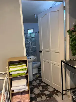 a bathroom with a toilet and a white door at 9 Guest - Unit 1 House Type in Pasong Mannga