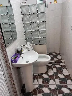 a bathroom with a white toilet and a sink at 9 Guest - Unit 1 House Type in Pasong Mannga