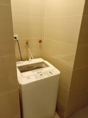 a small bathroom with a sink and a trash can at Beautiful High End Condo in City Center, Manila in Manila