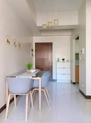 a dining room with a table and two chairs at Beautiful High End Condo in City Center, Manila in Manila