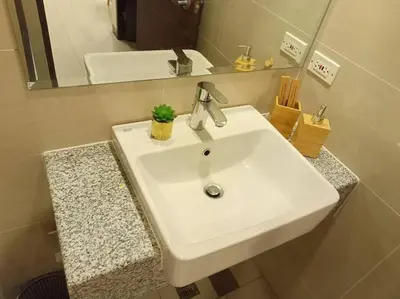a white sink in a bathroom with a mirror at Beautiful High End Condo in City Center, Manila in Manila